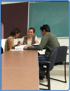 Three adults in a classroom setting.