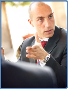 Male business professional talking during a meeting.