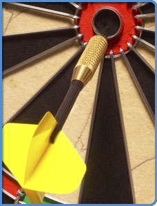 Dartboard target with an arrow in the bullseye.